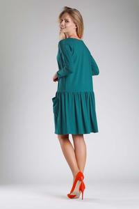 Green Dress with a Loose Fashion. Fastened with buttons